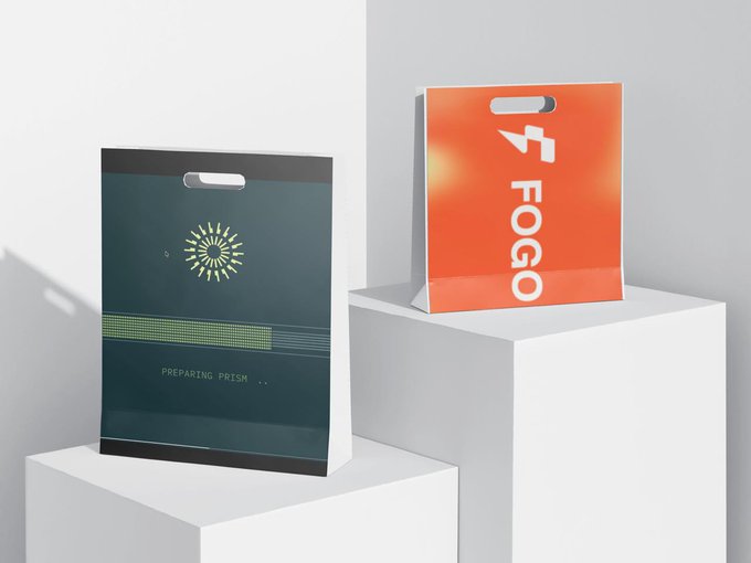 Two branded shopping bags on white pedestals: a dark teal bag with a starburst design reading 'PREPARING PRISM' and an orange bag reading 'FOGO'.