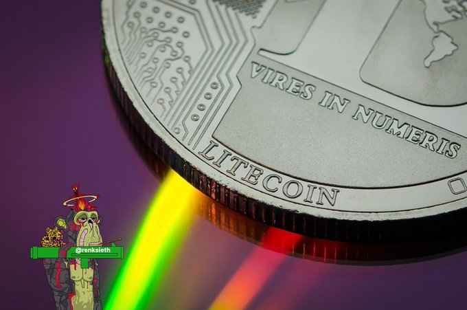 A close-up of a silver Litecoin coin displays the inscription "VIRES IN NUMERIS" and "LITECOIN," with vibrant rainbow light rays emanating from its edge—visually reinforcing the post's emphasis on $LTC as a dependable, straightforward cryptocurrency.