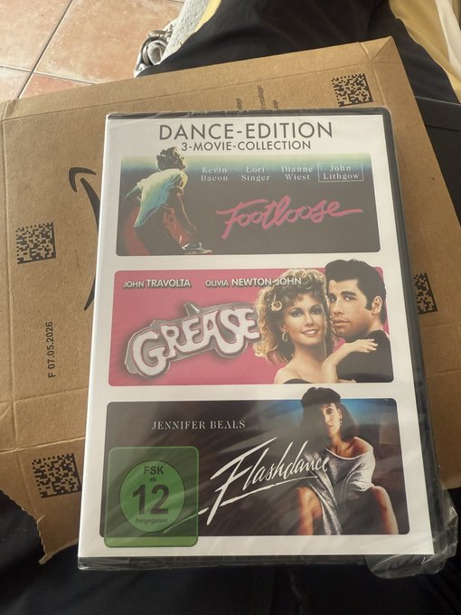 A German 'Dance-Edition 3-Movie-Collection' DVD set containing 'Footloose' (starring Kevin Bacon, Lori Singer, Dianne Wiest, John Lithgow), 'Grease' (starring John Travolta and Olivia Newton-John), and 'Flashdance' (starring Jennifer Beals), with an FSK 12 rating.