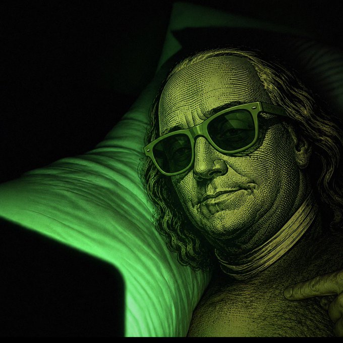 A stylized green-tinted image of Benjamin Franklin from a US dollar bill wearing modern sunglasses, lying down with his head on a glowing green pillow in a dark setting.
