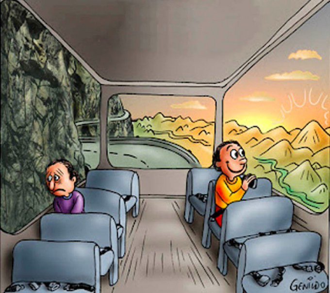 A cartoon by 'Genildo' showing two passengers on a bus traveling along a mountain road: a sad man on the left sees only a rocky cliff wall, while a happy child on the right gazes out at a beautiful sunset over mountains.