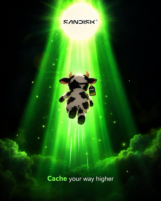 A SanDisk advertisement featuring a cow floating upward toward a glowing light, with the text "Cache your way higher" displayed at the bottom.