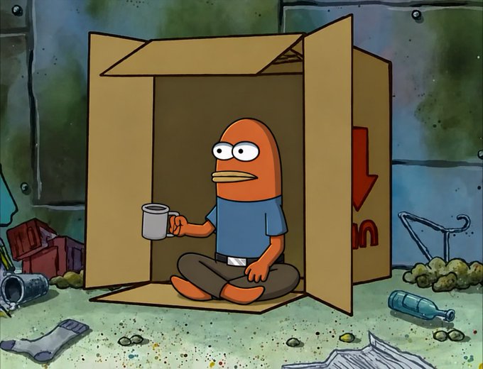 An orange fish character wearing a blue shirt sits cross-legged inside a cardboard box in a littered alley, calmly holding a mug. The image is shared alongside a post joking about "Monad trenches" being a sandbox for "NADS WEN" airdrops, mirroring the cartoon's depiction of someone living in a box as a humorous take on struggling memecoin trench-diggers.