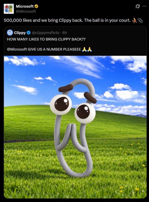A tweet from @Microsoft offers to bring Clippy back in exchange for 500,000 likes, quoting @clippymsftcto's plea for a specific number, with an image showing the iconic Clippy paperclip character standing on grass beneath a blue sky. The image illustrates how Microsoft's official X account was hijacked by crypto scammers promoting a "Clippy" meme coin.