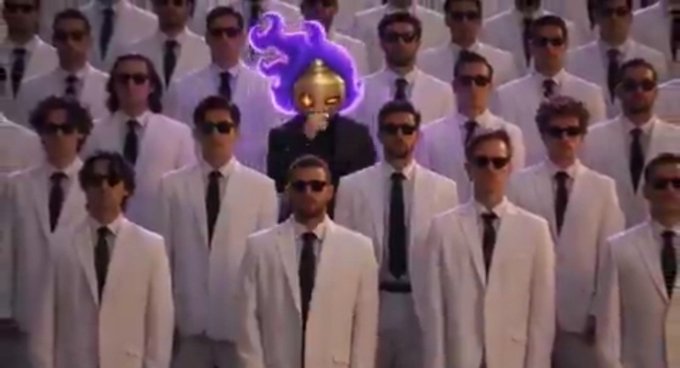 A surreal scene shows rows of identical men in white suits, black ties, and dark sunglasses, with one figure in the center wearing a black suit and having a glowing purple ghostly creature on their head.
