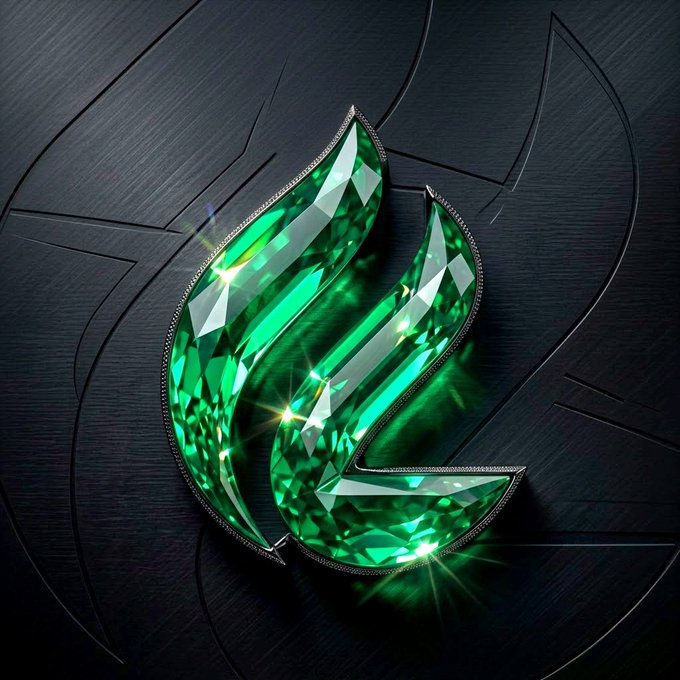 A decorative green emerald or gemstone design in a teardrop/leaf shape with diamond-encrusted edges, set against a dark metallic background with carved details.