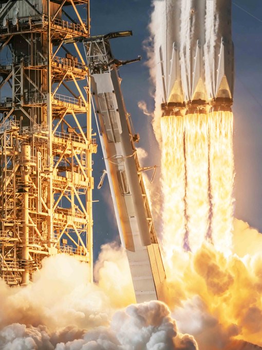 A massive rocket lifts off from its launch pad, with bright orange flames and billowing white smoke erupting from its engines as it ascends into a blue sky. The image metaphorically mirrors the post's theme of $SPCX breaking through the $150 resistance "wall," symbolizing a powerful upward breakthrough or launch in the stock's price.