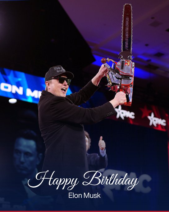 Photo of Elon Musk wearing a black cap and sunglasses, wielding a large chainsaw on stage at an XPMC event, overlaid with the text 'Happy Birthday Elon Musk'.