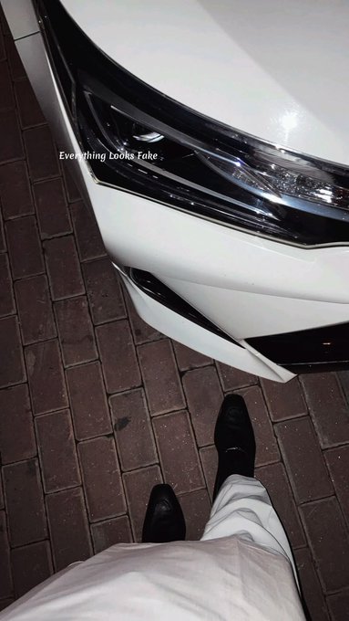 A first-person view looking down at an Instagram story showing feet in black shoes near a white car's headlight with the text 'Everything looks fake.'