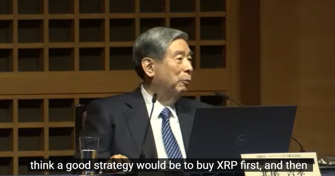 The image shows a man sitting at a desk with a laptop computer open in front of him. The text overlaying the image reads, "Think a good strategy would be to buy XRP first, and then". This suggests that the man is considering investing in Ripple, a cryptocurrency, as part of his trading strategy.
