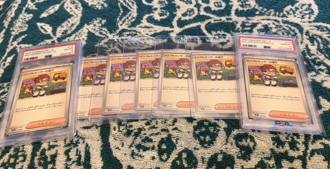 Eight PSA-graded Japanese Pokémon Vol.3 "イーブムしターの魅力" (Eevee's Appeal) Trainer cards are arranged in a row on a patterned rug, each slab labeled with PSA certification numbers. The caption highlights a successful pull or pickup of these graded Japanese exclusive cards, tying into the "Japan plug comes through once again" post.