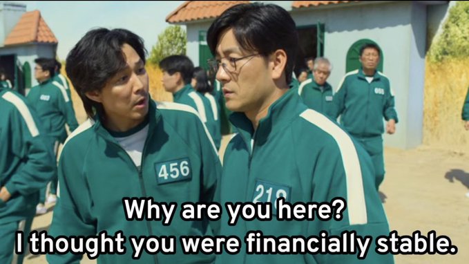 Two men in green tracksuits with numbers "456" and "218" on their chests (from *Squid Game*) exchange a skeptical glance, with subtitles reading, "Why are you here? I thought you were financially stable." The meme humorously draws a parallel to self-proclaimed crypto veterans whose financial ruin betrays their veteran status.