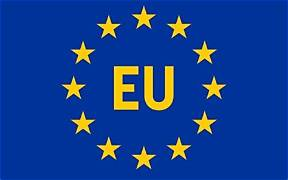 The flag of the European Union (EU) features a circle of twelve yellow stars on a dark blue background with the letters 'EU' in the center.