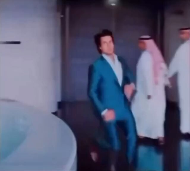 The image shows a man wearing a blue suit, dancing with his arms outstretched as if he's about to jump into an air cannon. The room has white walls and a white bathtub in the background. There are three people present in the scene - one person is standing near the bathtub, another person is standing further back on the right side of the image, and the third person is standing closer to the foreground with his arms crossed over his chest.

The post that accompanies this image reads: "Me on my way to buy $ETH now that the war is over". This message suggests a connection between the man's dancing and the current state of the world - perhaps as a metaphor for the end of conflict or an indication of a new era in which people can enjoy themselves without fear.