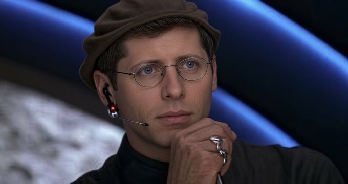 A man wearing a brown hat, wire-rimmed glasses, and a headset microphone, with a contemplative expression.