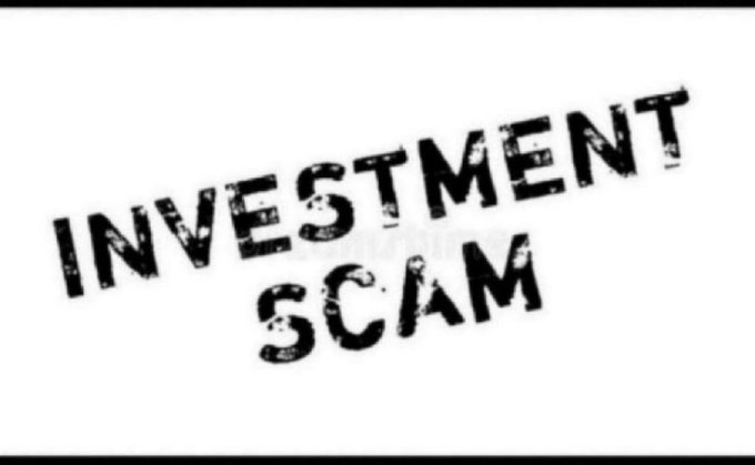 A black rubber stamp style image on white background displaying the text 'INVESTMENT SCAM' in bold distressed letters.