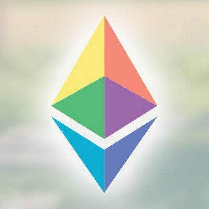 The image features a colorful, geometric-shaped logo that resembles an etherium token or cryptocurrency symbol. The logo consists of three triangles, each filled with a different color - yellow, green, and purple. The background of the image is white, which contrasts with the vibrant colors of the triangle shapes. The text "Ethereum has had two separate conversations lately" is written in black at the bottom right corner of the image.