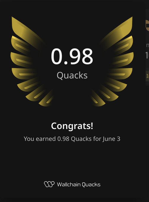The image features a black background with gold wings printed on it. The text "0.98 Quacks" is displayed below the wings, indicating the number of Quacks earned for the activity shown in the photo.