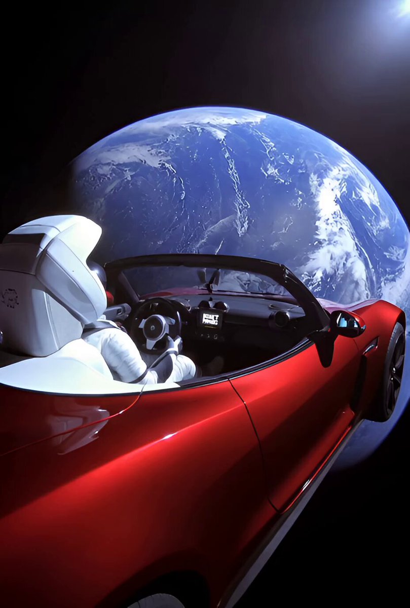 The image features a red sports car with a white driver, who appears to be an astronaut or a robot, driving around a globe. The caption "Don't panic" suggests that there might be some sort of problem or challenge related to the vehicle's operation in space. This could be due to technical issues, lack of gravity, or other factors unique to space travel and operating vehicles.