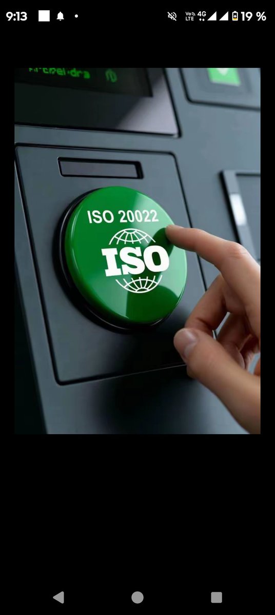 A hand presses a large green button labeled 'ISO 20022' with the ISO logo and globe emblem, set against a dark control panel.