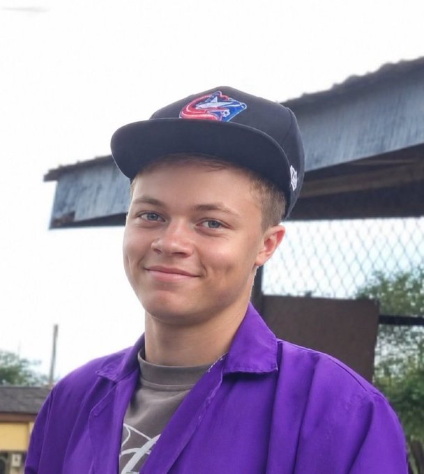 A young man wearing a Colorado Avalanche baseball cap and a purple shirt smiles at the camera against an outdoor backdrop with a chain-link fence. The image pairs with the "good morning legends" post to deliver an upbeat, motivational greeting.