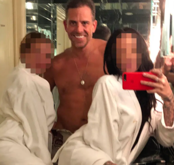A shirtless man posing with two people whose faces are pixelated, taking a mirror selfie in what appears to be a bathroom.