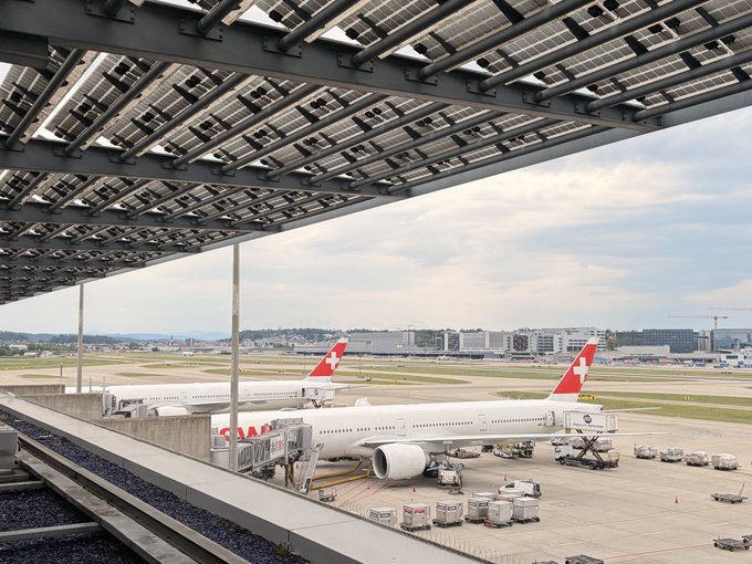 A view of two SWISS aircraft parked at jet bridges at Zurich (ZRH) airport, marking the start of the trip to the Science of Blockchain Conference (SBC) 2026 at Stanford.