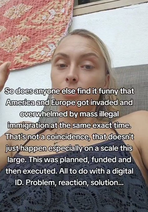 A blonde woman speaks directly to the camera in a casual setting, with overlaid text presenting a conspiracy theory about coordinated illegal immigration in America and Europe being linked to a digital ID agenda.