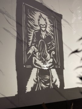 A black and white banner illustration shows a sinister figure holding a ghostly woman, with flames emanating from behind them.