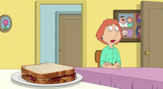 A woman with red hair sits at a table with a peanut butter and jelly sandwich in front of her, while a family photo hangs on the yellow wall behind her. The image appears to be a scene from an animated show, fitting the post's "GM" (good morning) greeting.