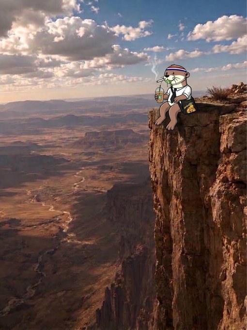 A small teddy bear wearing a striped beanie, white shirt, and backpack sits on the edge of a tall cliff overlooking a vast canyon landscape under a cloudy sky, casually drinking from a cup with chopsticks.