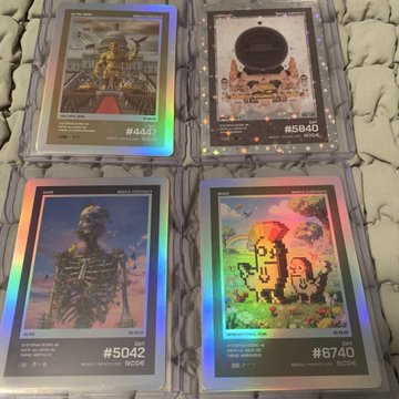 In the image, there are four CDs or cases that have a vibrant rainbow-colored foil over them. Each case features an album cover with different colors of the rainbow. The album covers display various artwork, including cartoon characters like a skeleton with human limbs standing upright and holding a beer. One of the cases is labeled "54", while another one has the number "48" on it. Another CD case shows a man standing in front of a castle or palace. Lastly, there is a CD case labeled "57" that displays a woman wearing a hat and holding flowers. The background of the image appears to be white with a patterned rug under it, and the post reads: "And our locks are locked into! @beeple x #nodefnd".