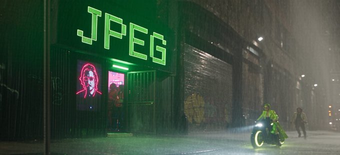 A rainy night scene featuring a building with a bright green neon 'JPEG' sign, a pink neon portrait in the doorway, and a person on a motorcycle with headlight illuminated in the foreground.