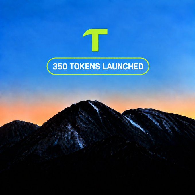 A promotional graphic showing a green 'T' logo with '350 TOKENS LAUNCHED' banner against a mountain sunset background.