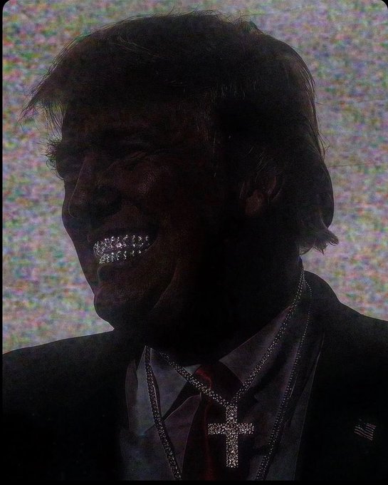 A dark, shadowy portrait of Donald Trump smiling, wearing a suit with a red tie and a jeweled cross necklace, with metallic teeth visible, set against a static-filled background.