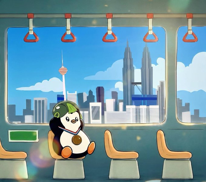 An animated illustration of a cute penguin mascot wearing a helmet and medal, sitting on a train seat with a cityscape featuring the Petronas Towers visible through the window.