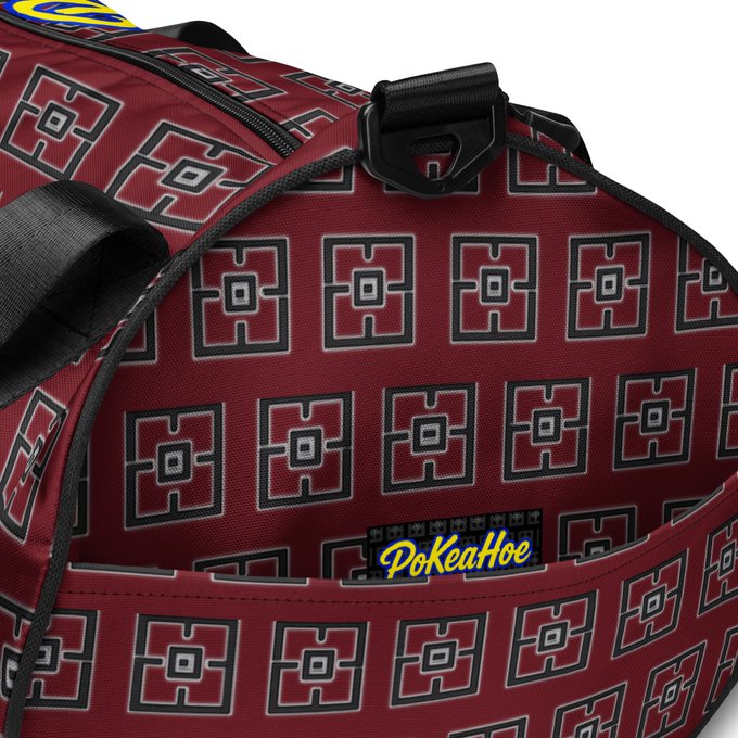 The interior view of a red backpack featuring a repeating geometric square pattern, with a yellow 'PokeaHoe' logo tag visible inside one of the pockets.