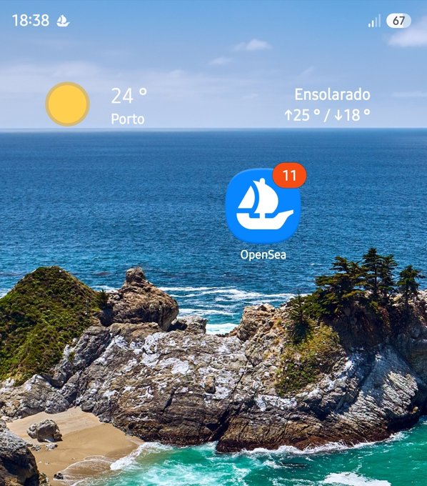 A smartphone home screen showing the weather in Porto (24°, sunny/Ensolarado, high 25°/low 18°) with the OpenSea app icon displayed showing 11 notifications, set against an ocean and rocky coastline wallpaper.