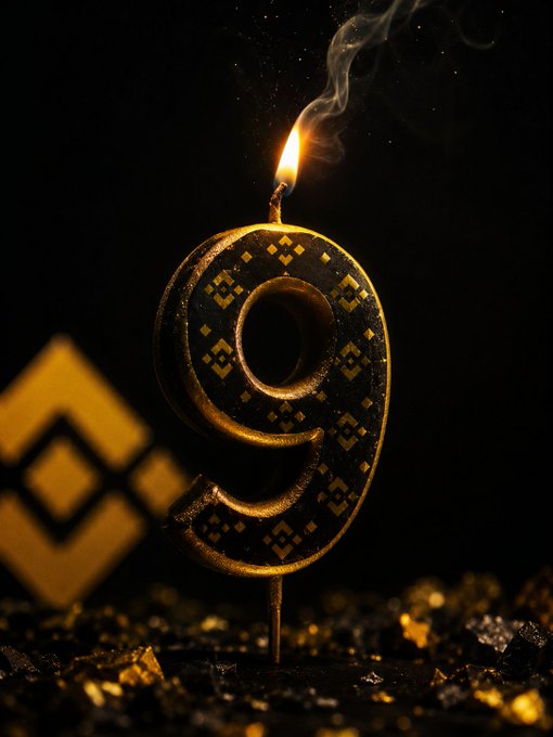 A decorative number "9" candle with gold geometric patterns glows brightly against a dark background, with a matching "0" visible in the blurred background.