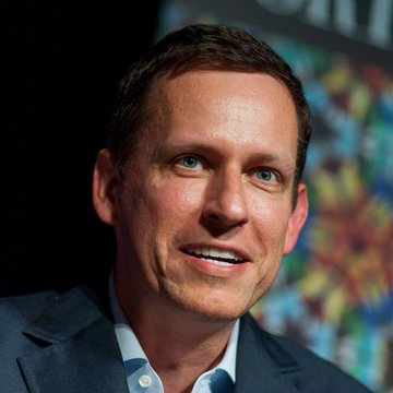 A man in a navy blazer and light blue shirt smiles on stage, illustrating the accompanying quote attributed to Peter Thiel praising Bitcoin as "the most honest and most efficient market in the world."