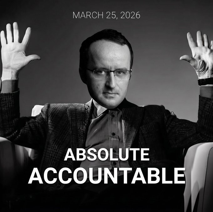 A black-and-white portrait of a man with glasses holding his hands up, labeled 'MARCH 25, 2026' and 'ABSOLUTE ACCOUNTABLE'.