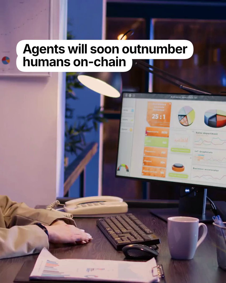 The image shows an office setting with a person sitting at a desk using a computer monitor, keyboard, and mouse. The background features a lamp and a plant, creating a comfortable workspace environment. A poster or advertisement related to AI agents and humans on-chain is displayed in the room, possibly discussing the implications of AI agents becoming more dominant than humans.