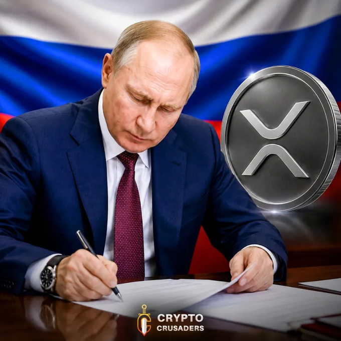 Russian President Putin is shown signing a document with an XRP coin superimposed next to the Russian flag, symbolizing new cryptocurrency regulations in Russia. The "Crypto Crusaders" logo is also visible.