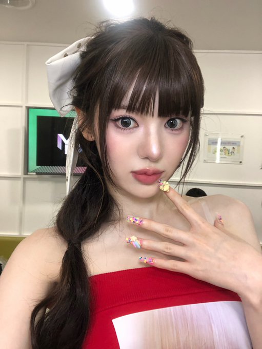 A young woman with long dark hair and blunt bangs poses playfully, showing off colorful 3D bubble-themed nail art in pastel hues, while wearing a red strapless top and a white bow in her hair. The caption "260814 #Sui Bubble" ties the image to an August 14, 2026 Sui cryptocurrency-themed post, creatively matching the bubble nail aesthetic to the "Sui Bubble" blockchain meme.