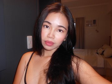 A woman with long dark hair poses for a selfie in what appears to be a hotel room, likely sharing a personal milestone moment as part of her June recap highlighting new opportunities and accomplishments.