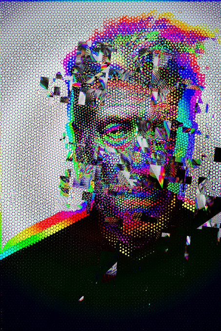 The image features an abstract portrait of a man with a face made up of small circles or dots. The colors used are predominantly red, blue, green, yellow, and purple. The background appears to be white, which contrasts with the colorful dots on the man's face. The caption below the image reads "Defragment Lynch If you'r a Lynch fan, this piece is for you."