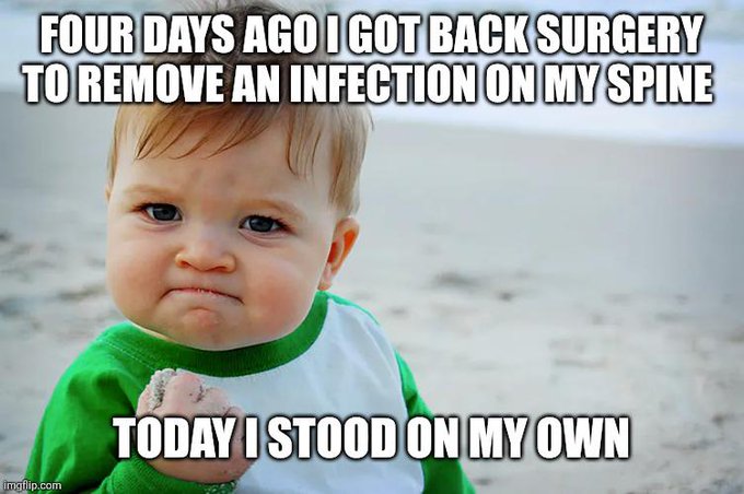 The image features a baby wearing a green shirt with white sleeves, standing on a beach. The baby appears to be making a funny face or expression as if they are trying to make people laugh. The caption of the image reads "Today I stood on my own" and is related to the post in some way.