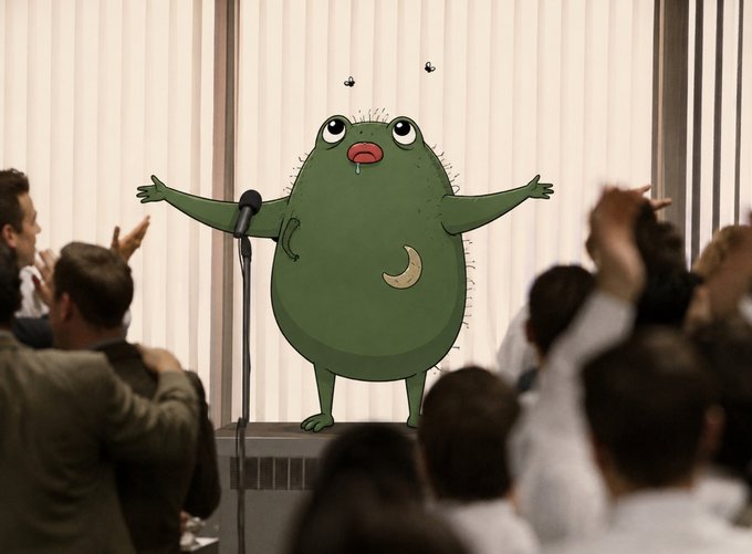A green cartoon character standing on a stage with arms outstretched, appearing to sing into a microphone. An audience is shown clapping in the foreground.