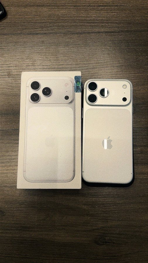 A still-sealed iPhone 17 Pro Max box in white sits on a wooden table next to the actual device, shown face-down to display its triple-lens camera and Apple logo. The unopened packaging alongside the phone reinforces the post's claim of a quick and profitable resale, as the owner appears to have sold the sealed unit shortly after purchase to recoup their investment.