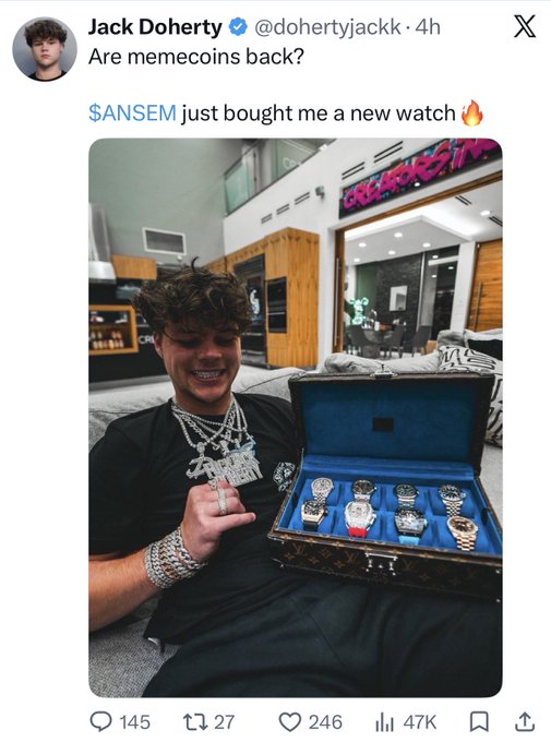 A screenshot of a tweet by Jack Doherty (@dohertyjackk) reads "Are memecoins back? $ANSEM just bought me a new watch 🔥" alongside a photo of a smiling young man wearing chains and holding a Louis Vuitton watch box displaying a collection of luxury watches. The post illustrates the claim about grifters returning to crypto, as the influencer showcases material wealth purportedly gained from the $ANSEM memecoin.